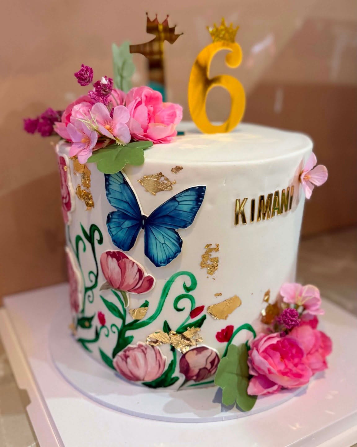 A hand-painted Sweet Endings birthday cake with sugar flowers and gold leaf